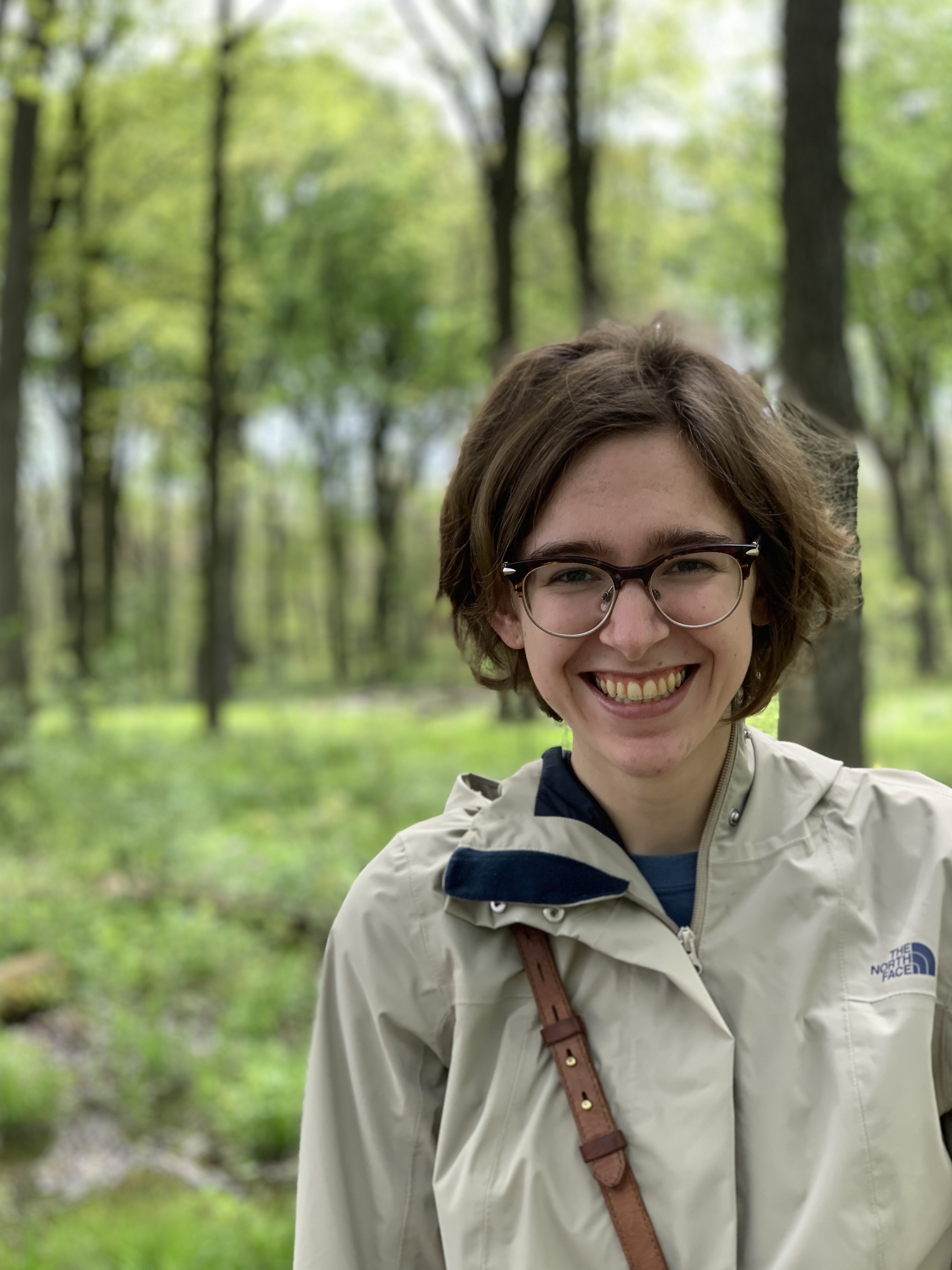 Image of Sarah LaVanway smiling in a forest